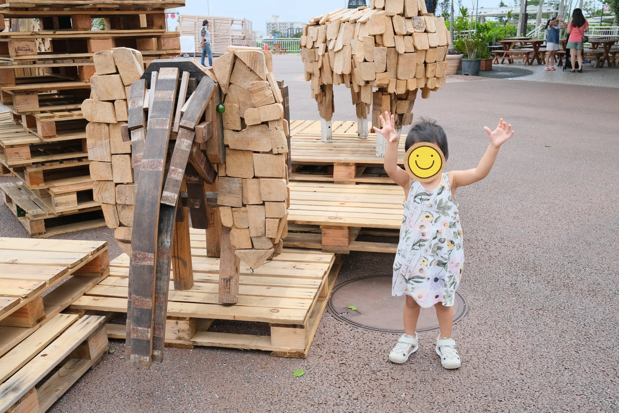 Taking a photo with the wooden elephant